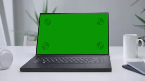 Modern Laptop Computer on White Desk with Blank Empty Green Mockup Screen Stock Footage 252686095