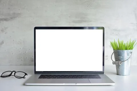 Modern laptop computer white screen on desk table front view Foto stock