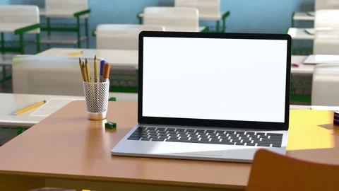 Modern laptop with white blank screen placed on desk against classroom at sch Stock Footage 204152658
