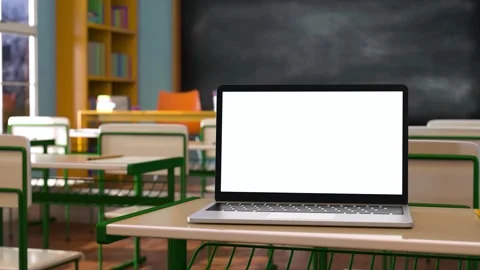 Modern laptop with white blank screen placed on desk against classroom at sch Stock Footage 204152695