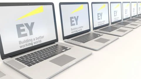 Modern laptops with Ernst &amp; Young logo. Computer technology conceptual editorial Illustrazione stock