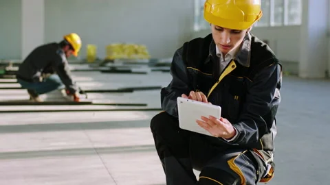 In a modern large construction site building engineer woman with protective Stock Footage 170144145