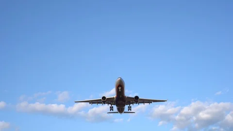 Modern large plane flies in the blue sky. White clouds in the background. 4K Stock Footage 117376769