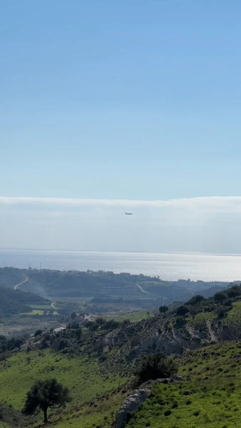 Modern large plane flies in the sky. Beautiful blue sky and white fluffy clouds Stock Footage 233590053