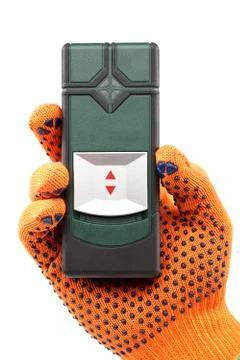 Modern laser measuring level in hand with glove. Stock Photos