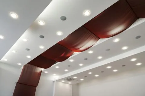 Modern layered ceiling with embedded lights and red cloth Stock Photos