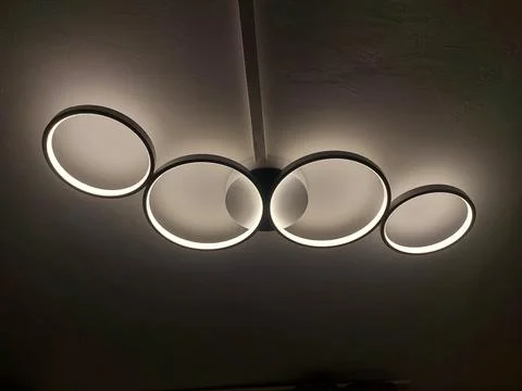 Modern LED Ceiling Light Fixture with Interlocking White and Black Rings Stock Photos