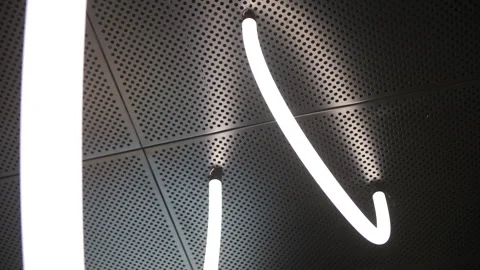 Modern LED light fixture on perforated metal ceiling Stock Footage 311048346