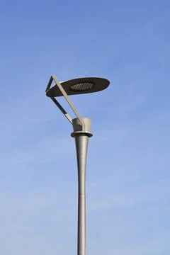 Modern led street light post against blue sky Stock Photos