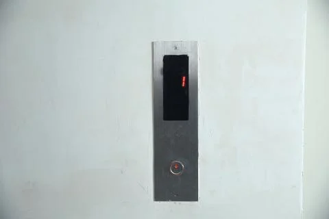 The modern lift button panel on stone tite wall close up background. Here are Stock Photos