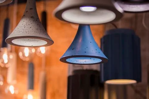 Modern light bulbs in a cafe. Ceiling light fixtures. Chandelier from cement. Stock Photos