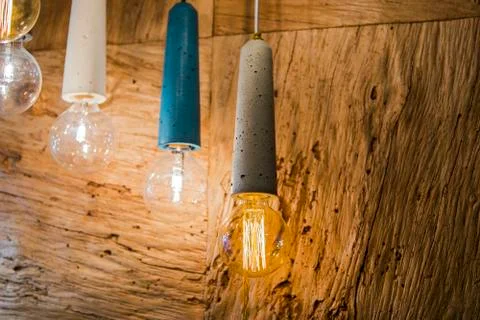 Modern light bulbs in a cafe. Ceiling light fixtures. Chandelier from cement Stock Photos