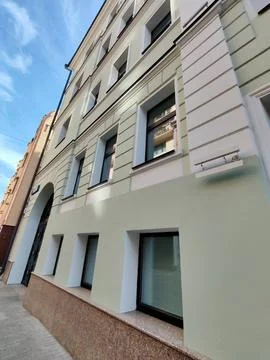 A modern light-colored building facade with large rectangular windows and a 스톡 사진