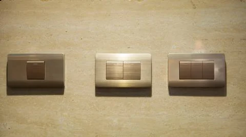 Modern light electrical switch with modern marble background. Stock Photos