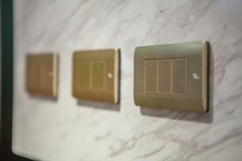 Modern light electrical switch with modern marble background. Stock Photos
