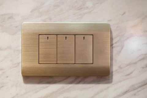 Modern light electrical switch with modern marble background. Stock Photos