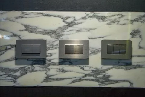 Modern light electrical switch with modern marble background. Stock Photos