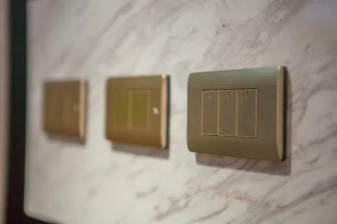 Modern light electrical switch with modern marble background. Stock Photos