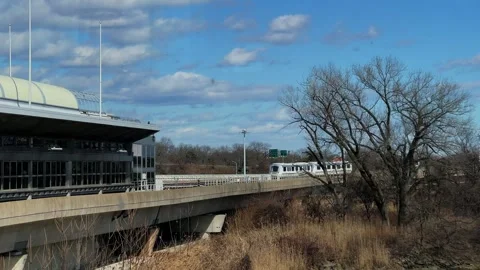 Modern light rail station featuring a train that is currently in motion departs Vídeo Stock 291635310