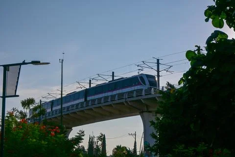 Modern light rail train crossing bridge in Zapopan urban landscape view Stock Photos