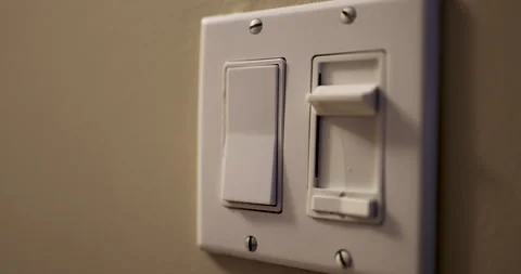 Modern Light Switch and Manual Dimmer Control on Interior Wall Stock Footage 329326409