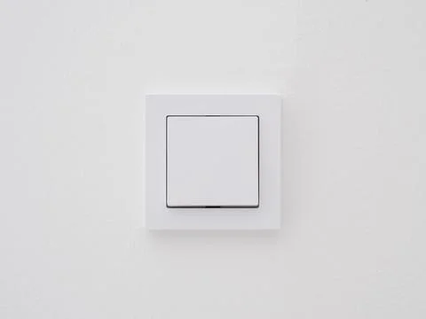 Modern light switch in the wall. Stock Photos