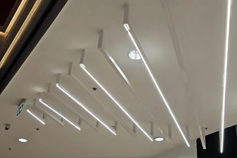 Modern Linear LED Ceiling Lighting Design in Commercial Space. Stock Photos