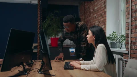 Modern loft office, black man and caucasian woman programmers and data analyst Stock Footage 233740131