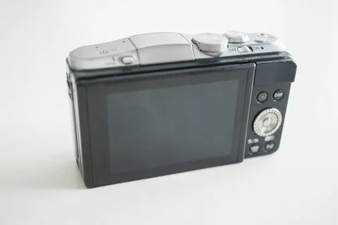 A modern-looking mirrorless digital camera, its back facing out Stock Photos
