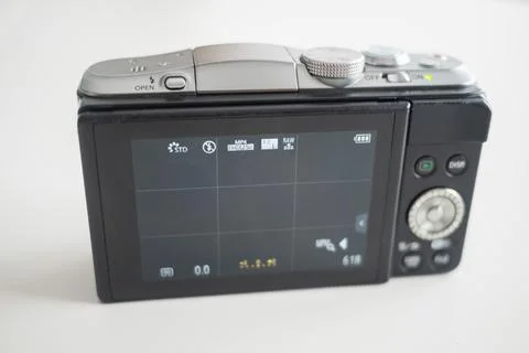 A modern-looking mirrorless digital camera, its back lit Stock Photos