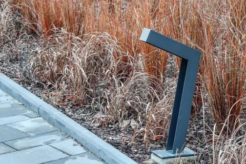 A modern low light illuminating the path in a residential complex. metal cons Stock Photos