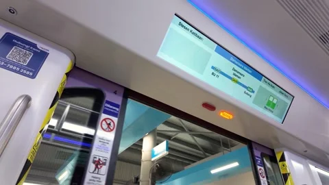 Modern LRT 3 train in Malaysia as the automatic passenger doors are closing Stock Footage 342414521