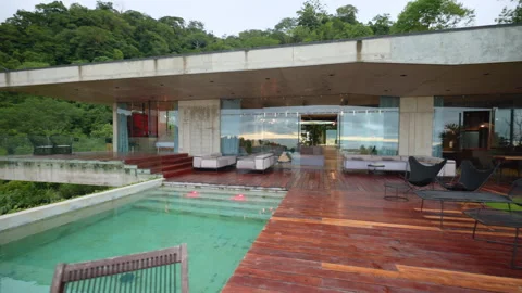 Modern Luxury Villa with Infinity Pool and Wooden Deck in Tropical Rainforest. Stock Footage 338367030