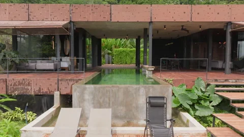Modern luxury villa with infinity pool surrounded by tropical rainforest. Stock Footage 339113231