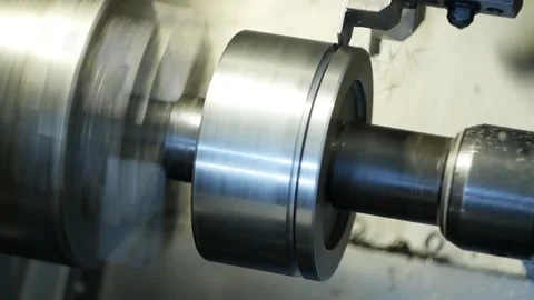 Modern machine computer numerical control grinds metal part in factory Stockbeeldmateriaal 104540114