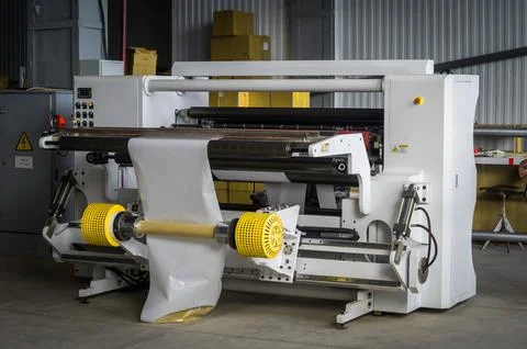 Modern machine for cutting large rolls of white paper for printing houses with Stock Photos