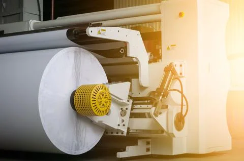 Modern machine for cutting large rolls of white paper for printing houses with Stock Photos