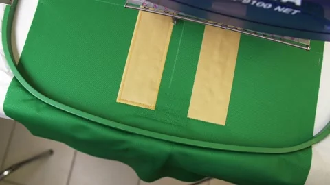 Modern machine emborders pattern on hockey team uniform Stock Footage 146020090