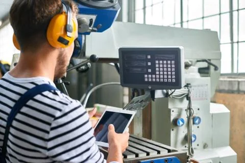 Modern Machine Operator at factory Stock Photos
