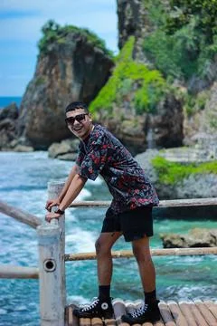 Modern man on bridge railing with view sea	 Stock Photos