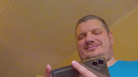 Modern man happily checking his smartphone screen Stock Footage 335382250