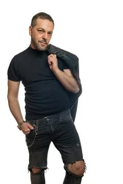 Modern man posing with leather jacket thrown over Stock Photos