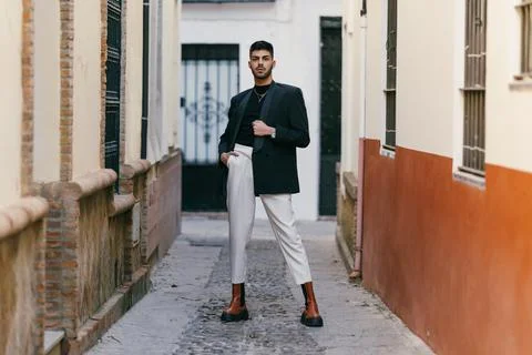 Modern man posing looking at the camera with a cocky expression outdoors Stock Photos