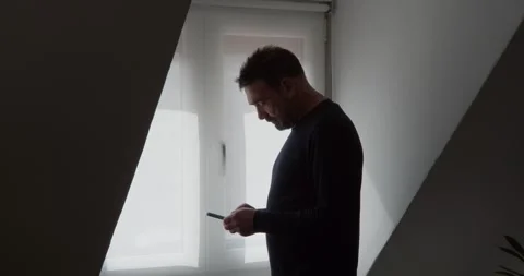 A modern man, shrouded in shadow. Video stock 331538311