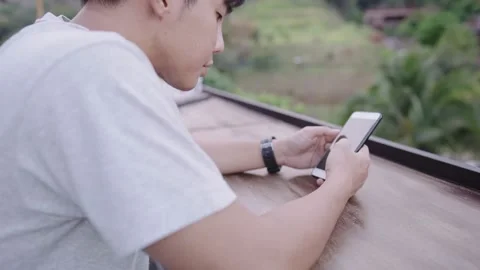 Modern man sliding on app looking at friends new feeds, vacation and technology Stock Footage 150718428