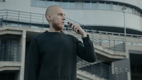 Modern man vaping outside in the warm summer evening Stockbeeldmateriaal 85611230