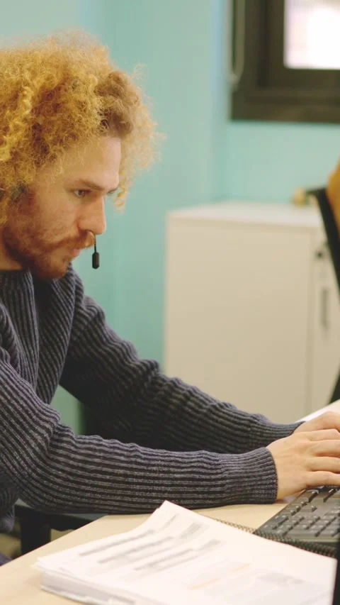 Modern man working in a coworking using computer and headset Stock Footage 272288234