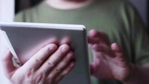 Modern man working from home with a tablet Stock Footage 297704306