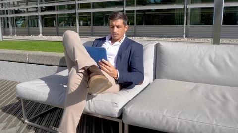 Modern man working outside on tablet in business park 4K Stock Footage 96056228