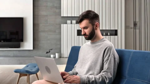 Modern man working remotely laptop browsing internet analyzing information Stock Footage 229715127
